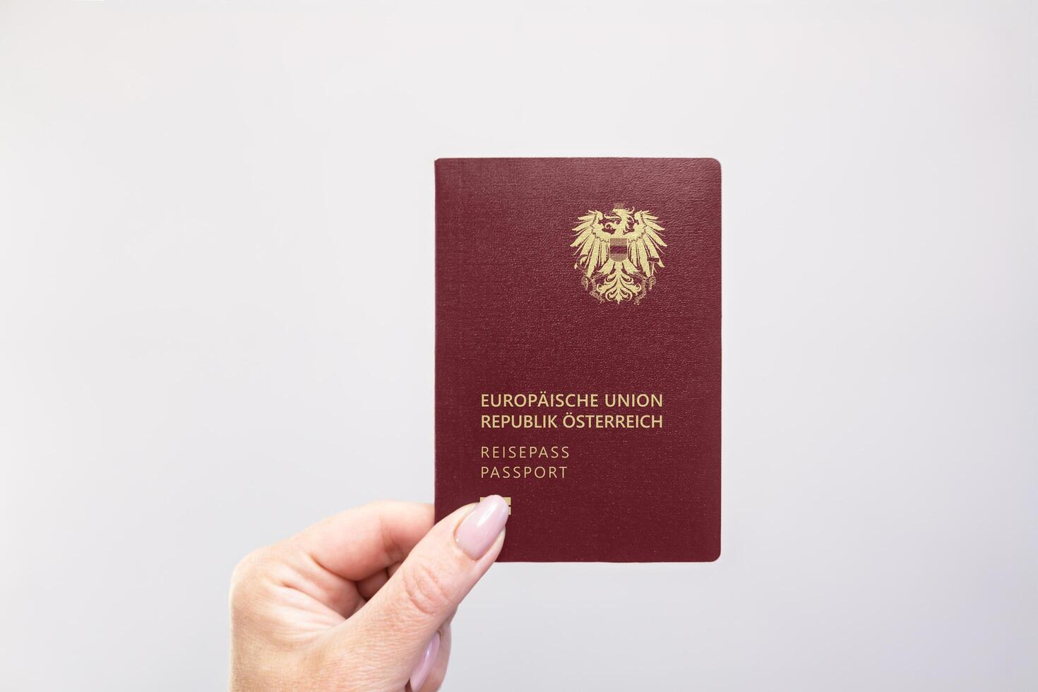 Austria Passport Held Against Simple White Background. Astana, Kazakhstan, 26 october 2024 photo