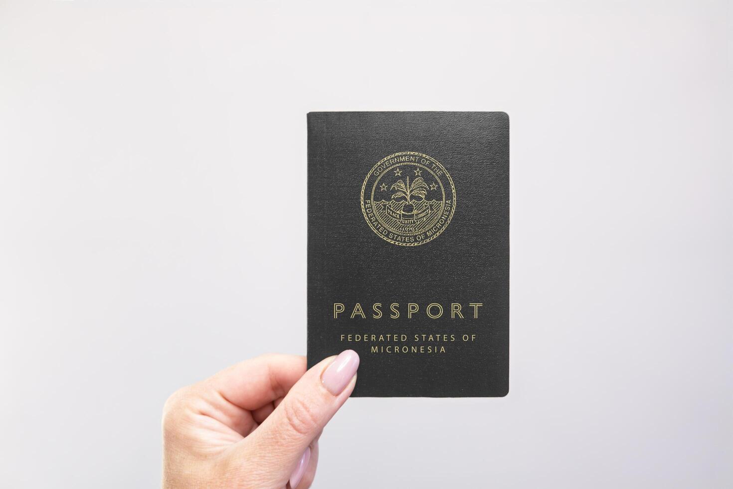 Passport Micronesia Held Against Simple White Background. Astana, Kazakhstan, 26 october 2024 photo