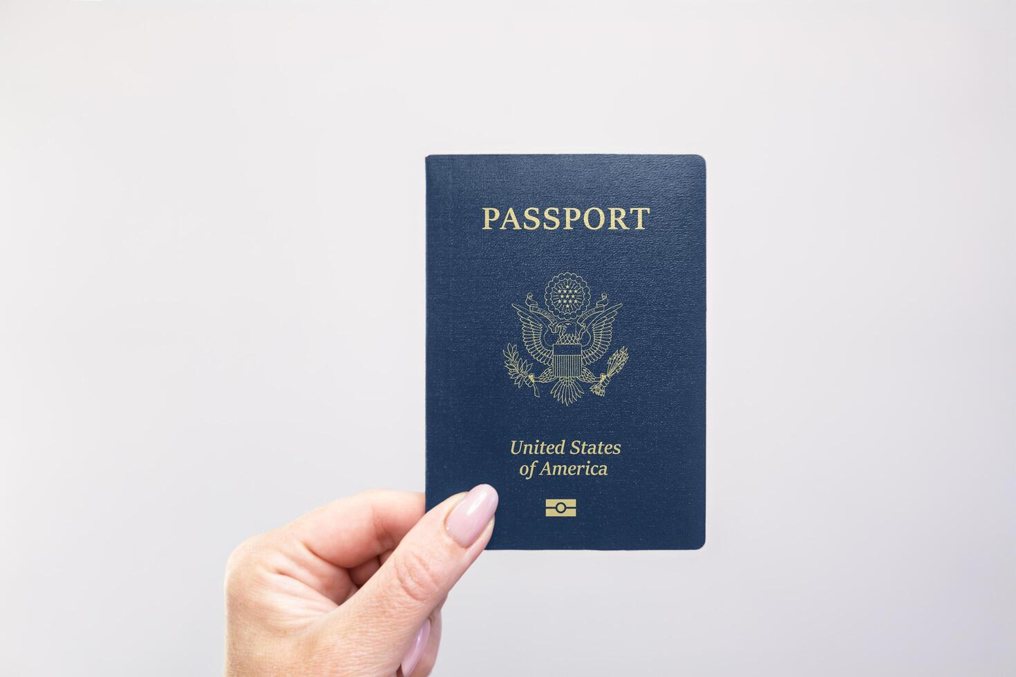 Passport United States Held Against Simple White Background. Astana, Kazakhstan, 26 october 2024 photo