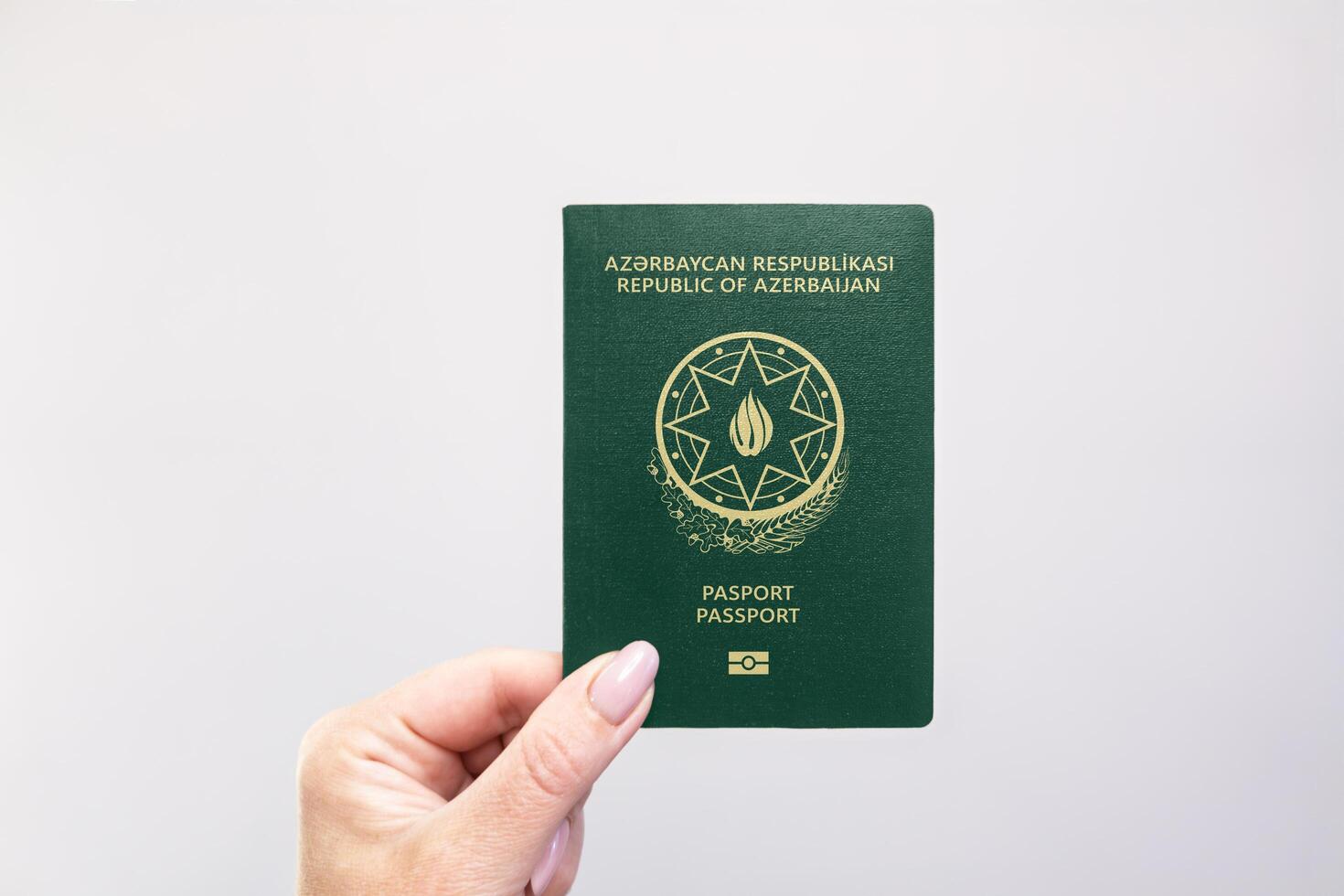 Azerbaijan Passport Held Against Simple White Background. Astana, Kazakhstan, 26 october 2024 photo