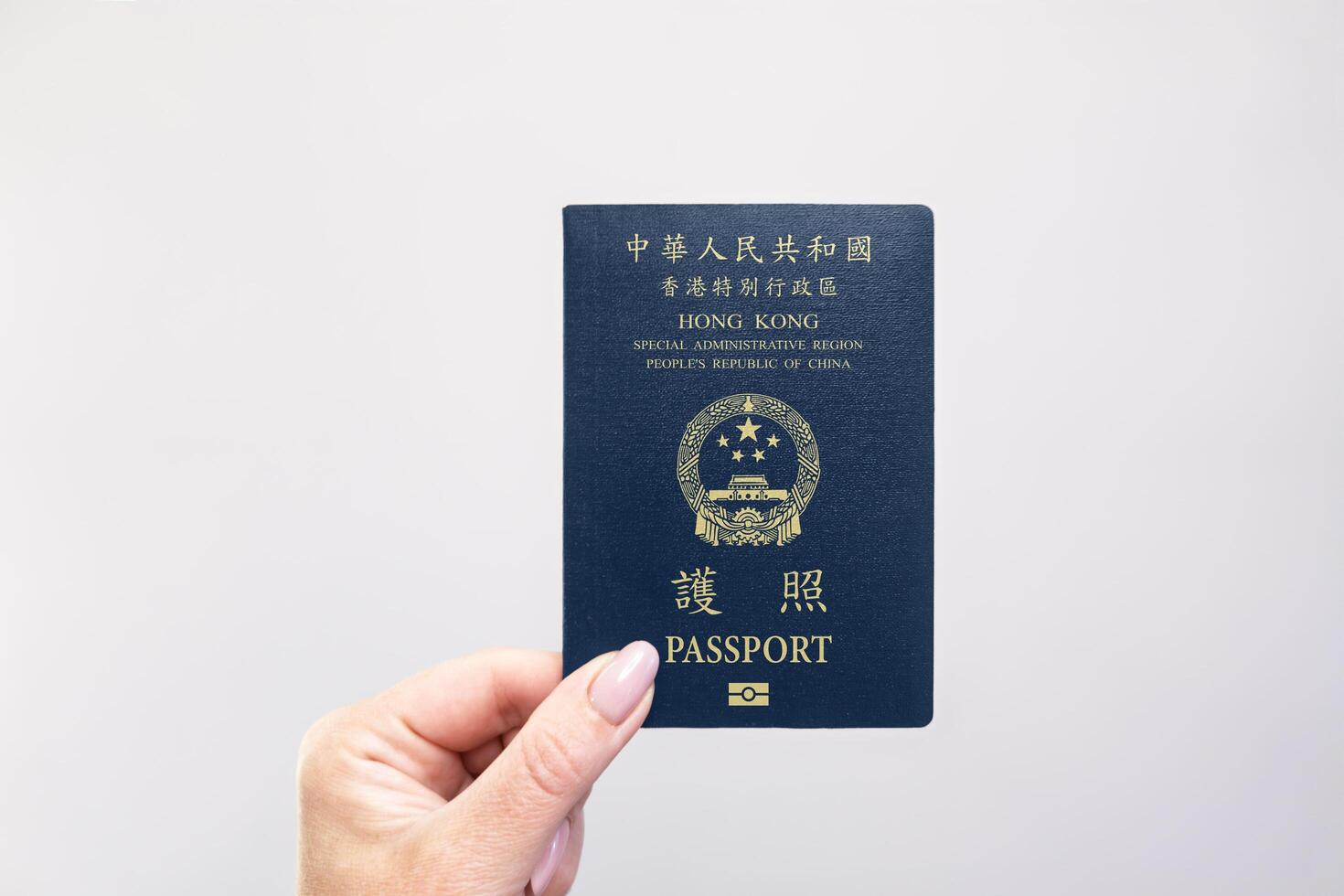 Passport Hong Kong Held Against Simple White Background. Astana, Kazakhstan, 26 october 2024 photo