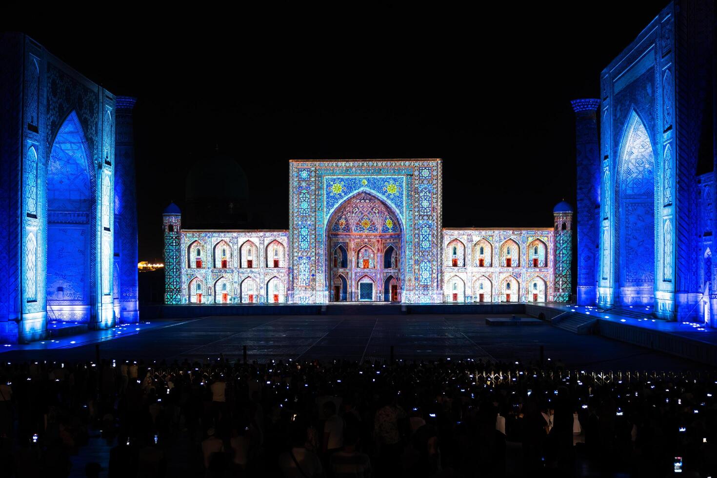 Samarkand, Uzbekistan-august 12, 2023-People in Registan Square watching a light show that illuminates all the buildings in the square during a summer night photo
