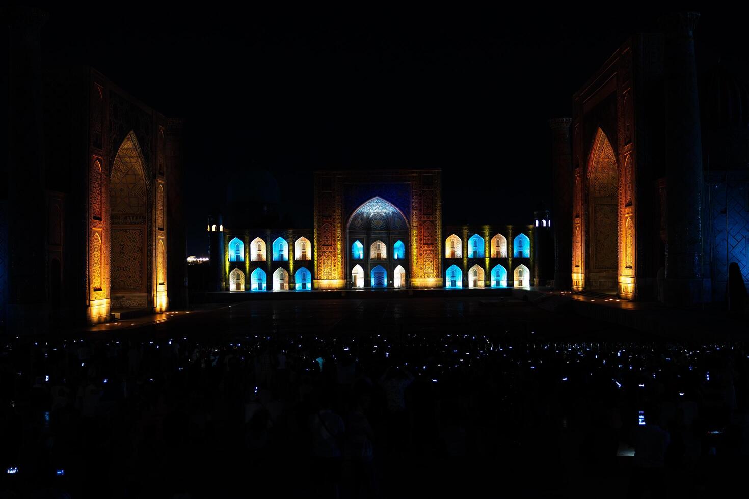 Samarkand, Uzbekistan-august 12, 2023-People in Registan Square watching a light show that illuminates all the buildings in the square during a summer night photo