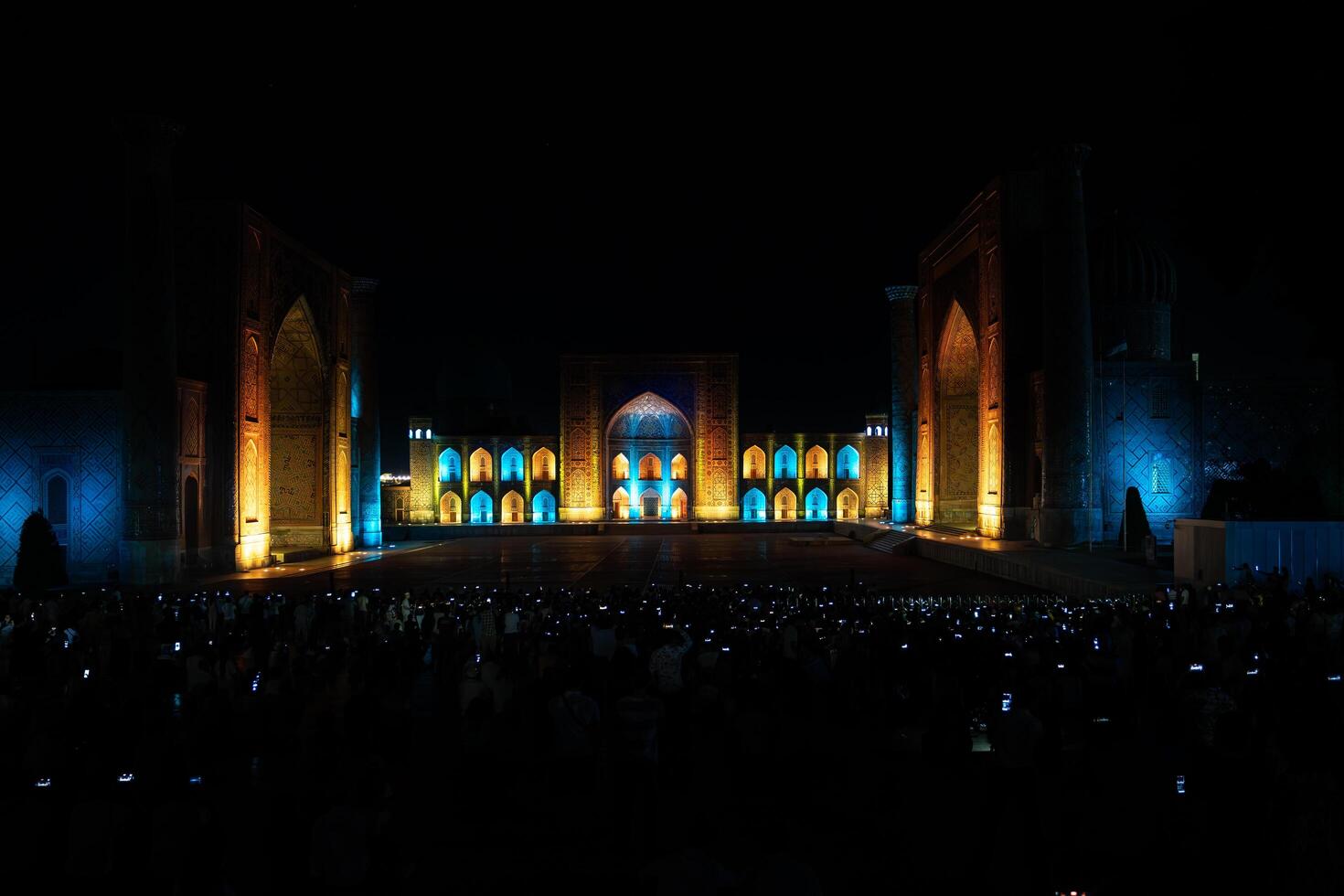 Samarkand, Uzbekistan-august 12, 2023-People in Registan Square watching a light show that illuminates all the buildings in the square during a summer night photo