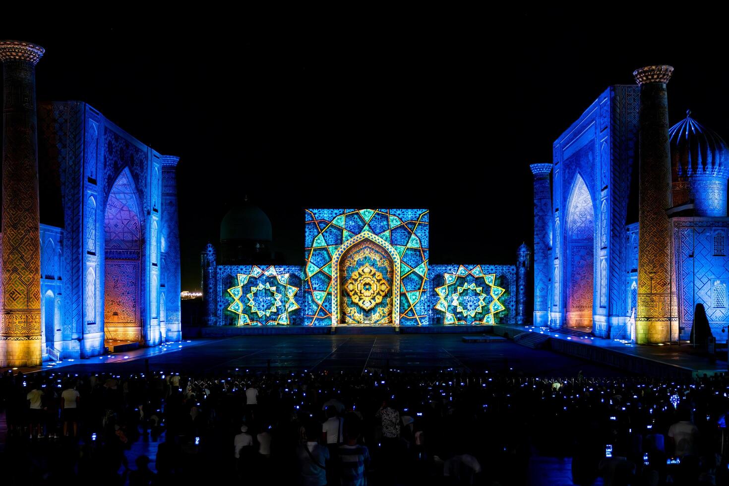 Samarkand, Uzbekistan-august 12, 2023-People in Registan Square watching a light show that illuminates all the buildings in the square during a summer night photo