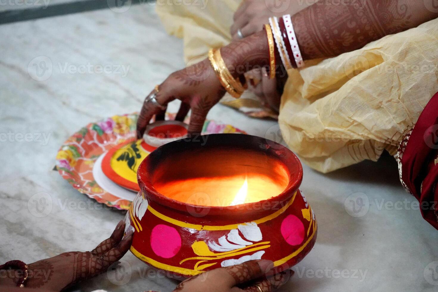 Performing ritual by bride at Indian Bengali Wedding photo