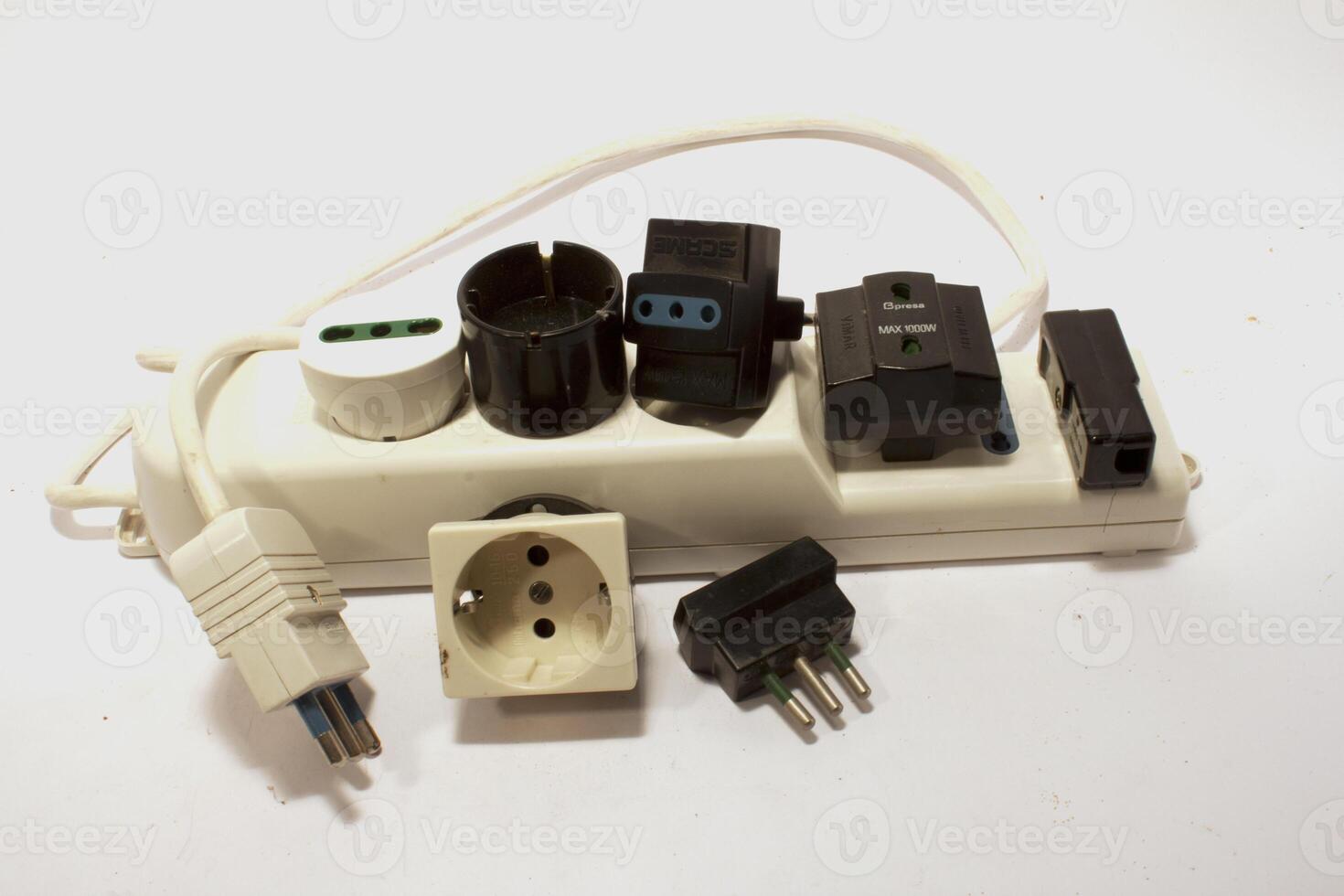 A white electrical outlet with several different types of plugs photo