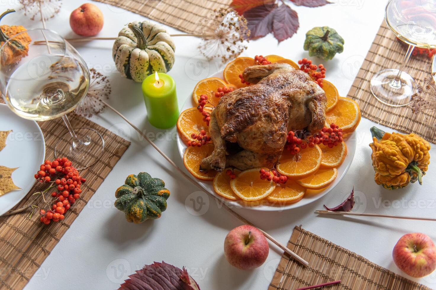 Stylish Thanksgiving table setting with beautifully candles and festive dishes photo