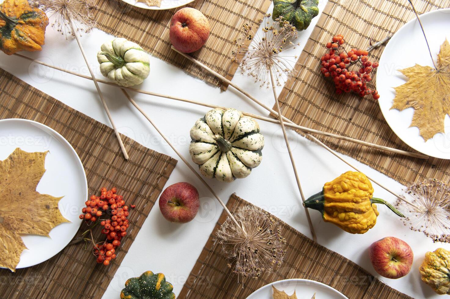 Thanksgiving Tablescape with pumkins and autumn leaves photo