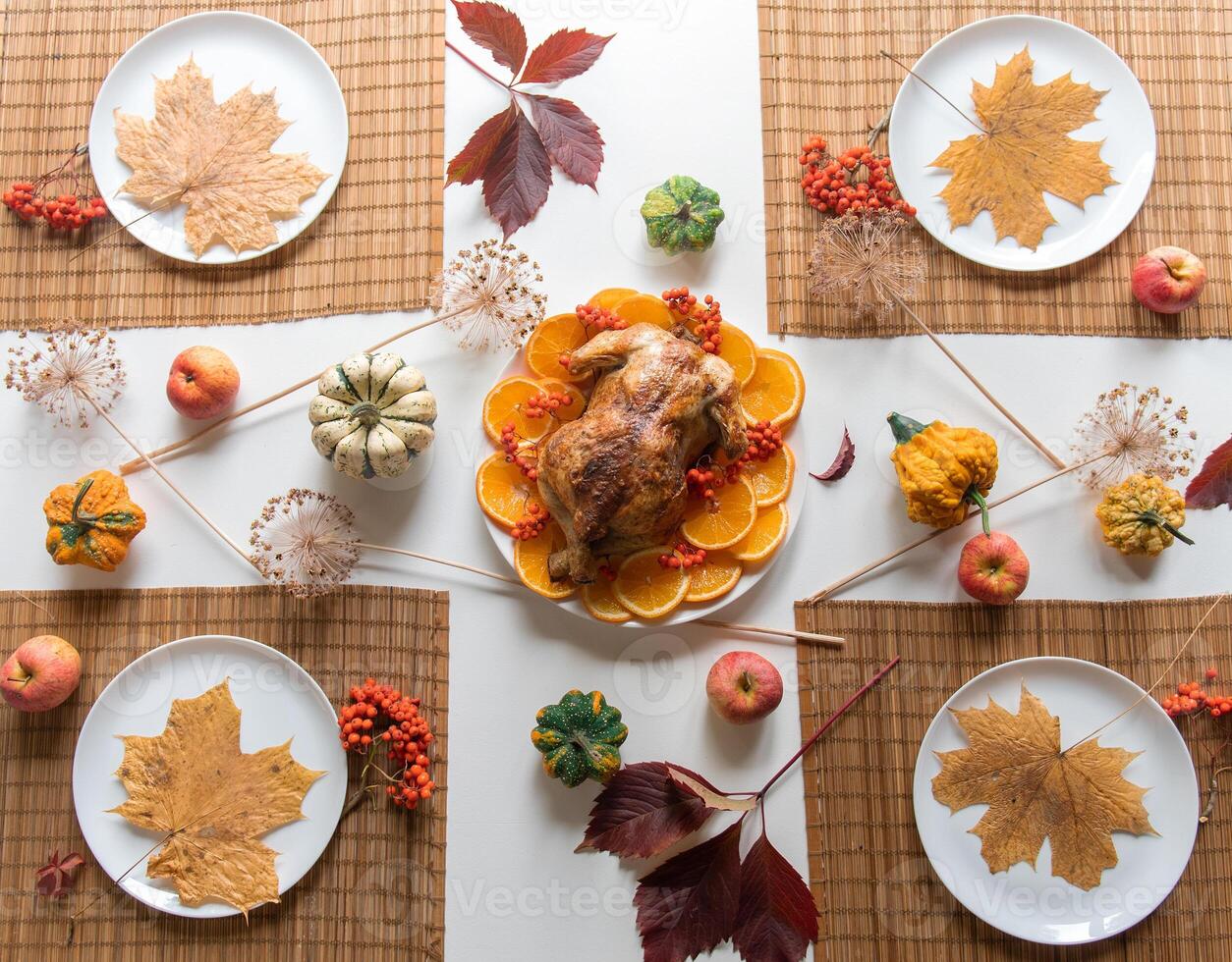 Thanksgiving traditional dinner food concept. Top view on roasted turkey on a decorated table photo