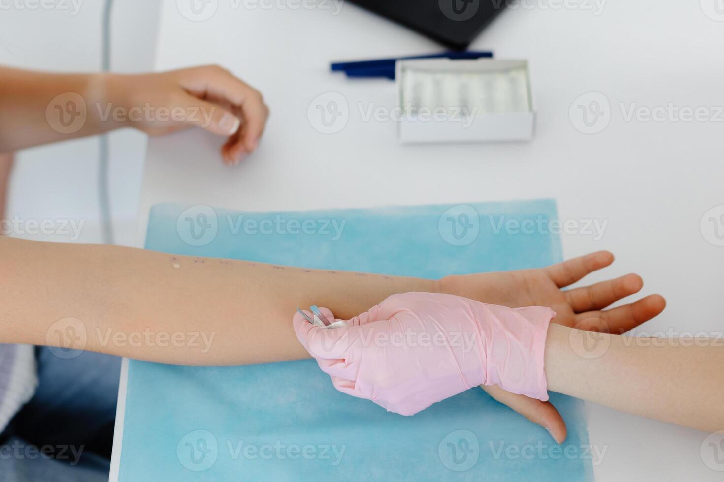 Doctor doing skin allergy test at white table in office. Allergy test - skin allergy testing for possible allergens photo