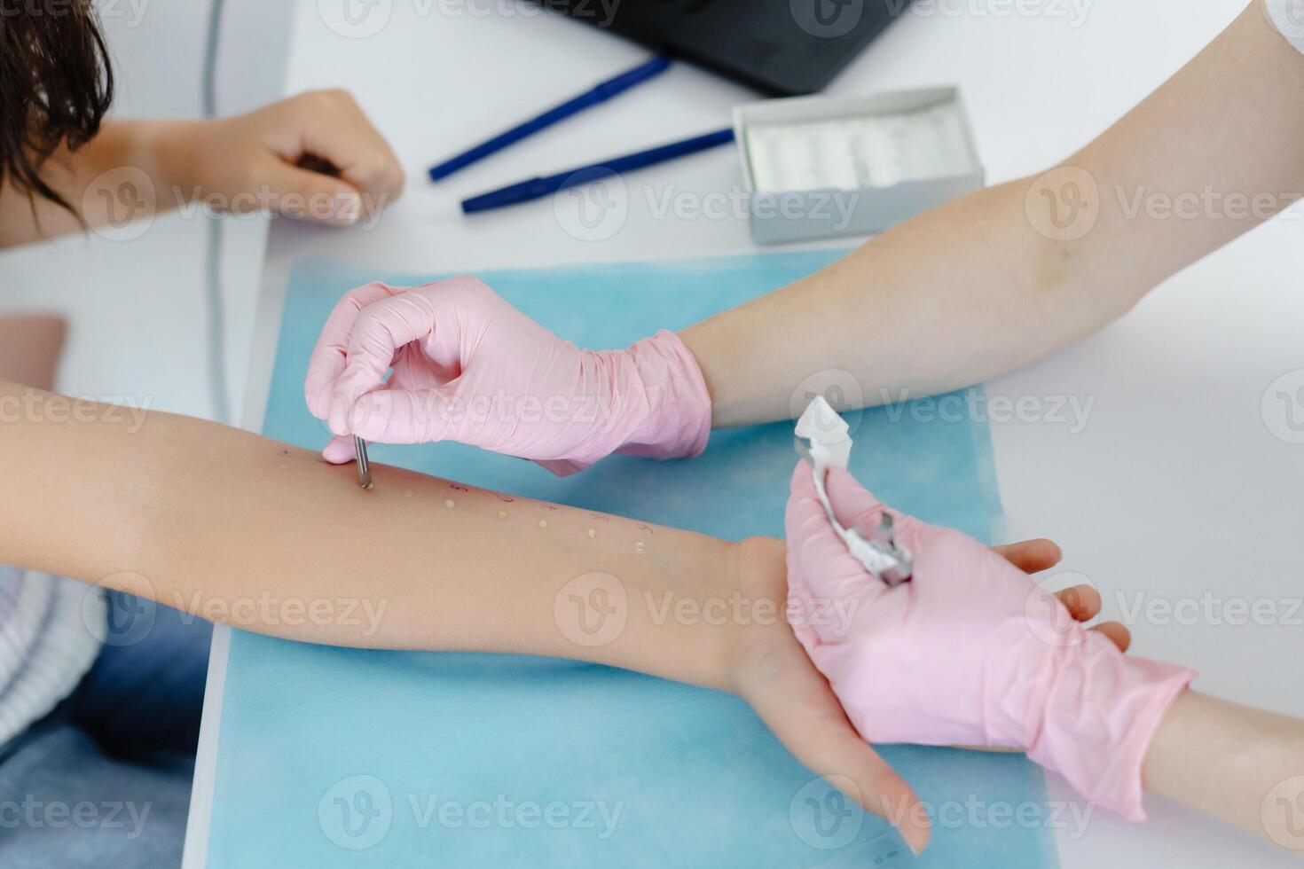 Doctor doing skin allergy test at white table in office. Allergy test - skin allergy testing for possible allergens photo