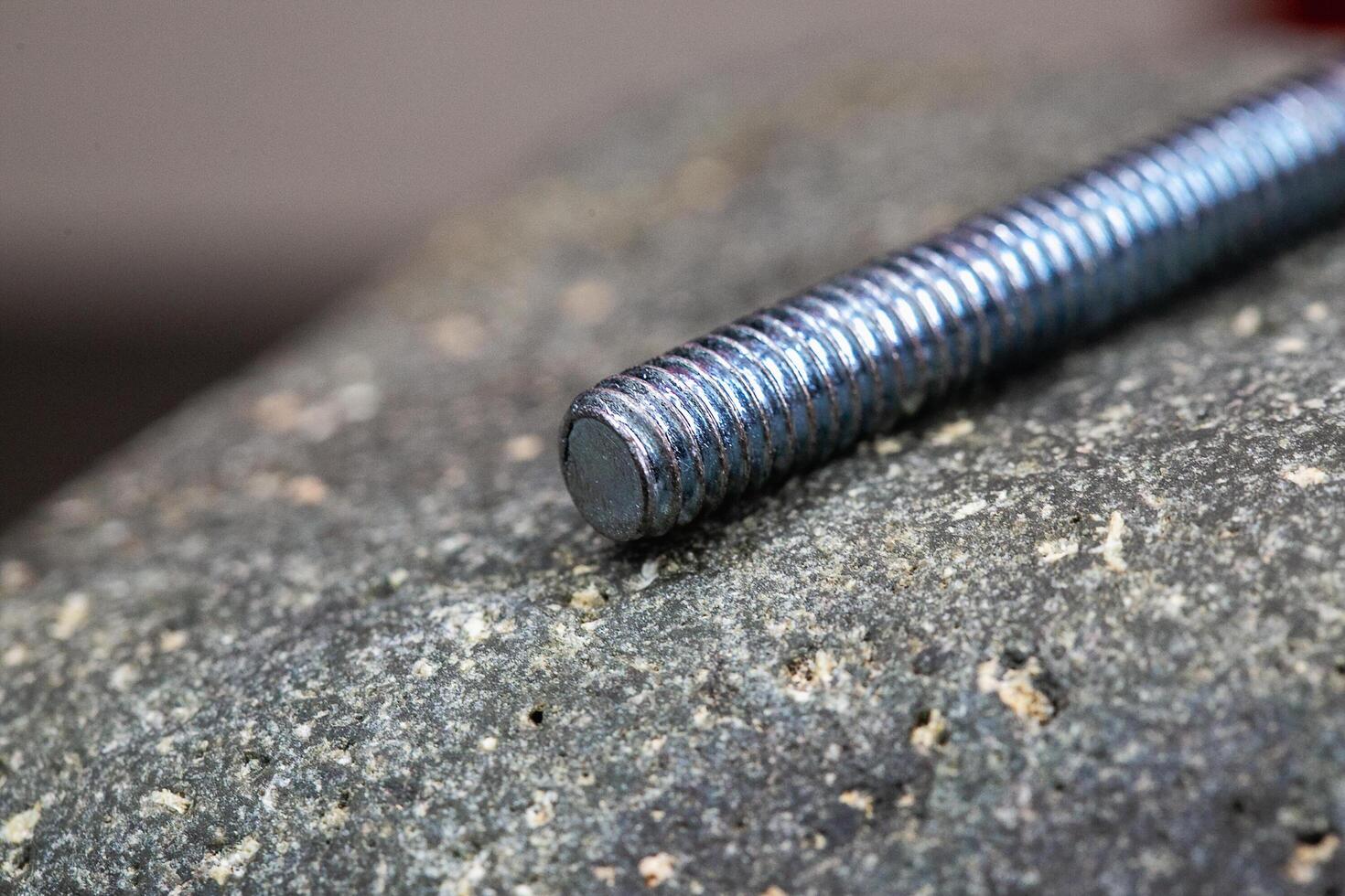 Close up of a screw on a rock photo