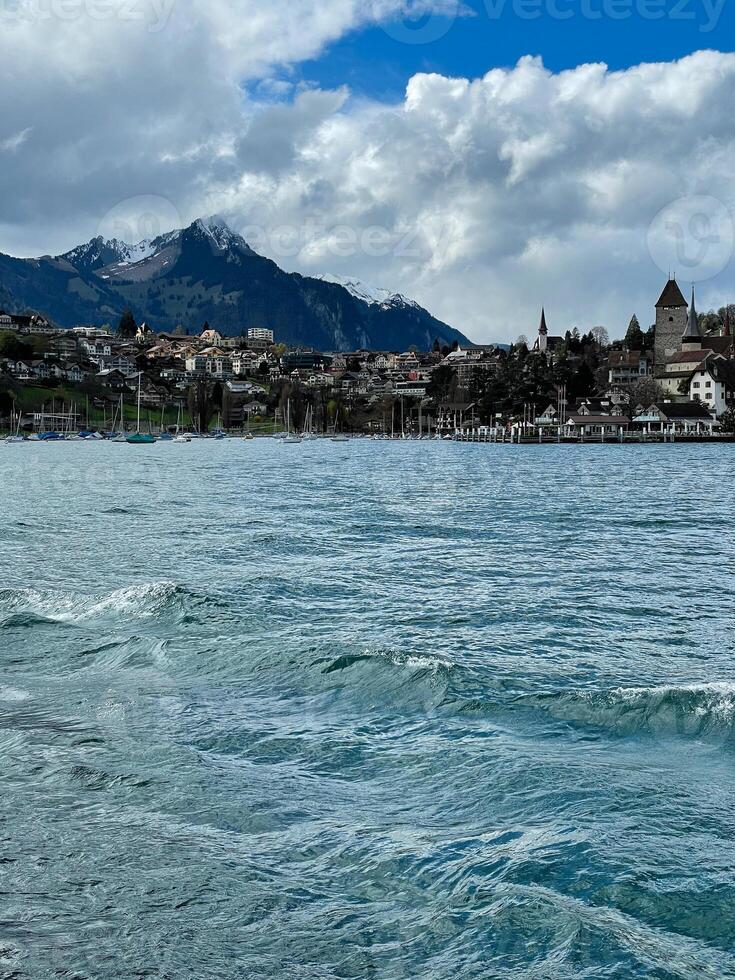 View of sailboats and surrounding villages along Lake Thun. Switzerland. photo