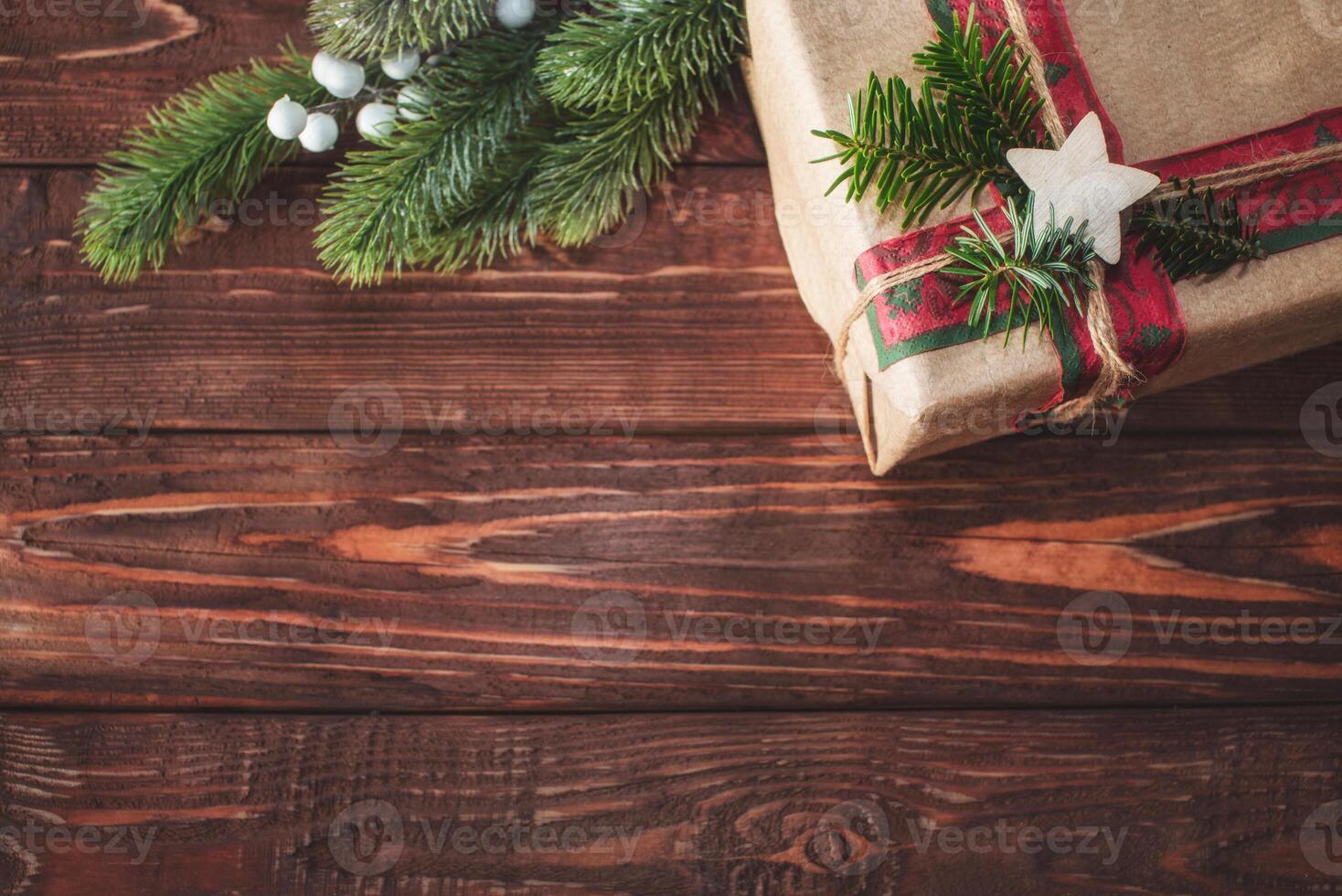 Christmas background with gift box and fir branches. Xmas and New Year theme. Space for text. photo