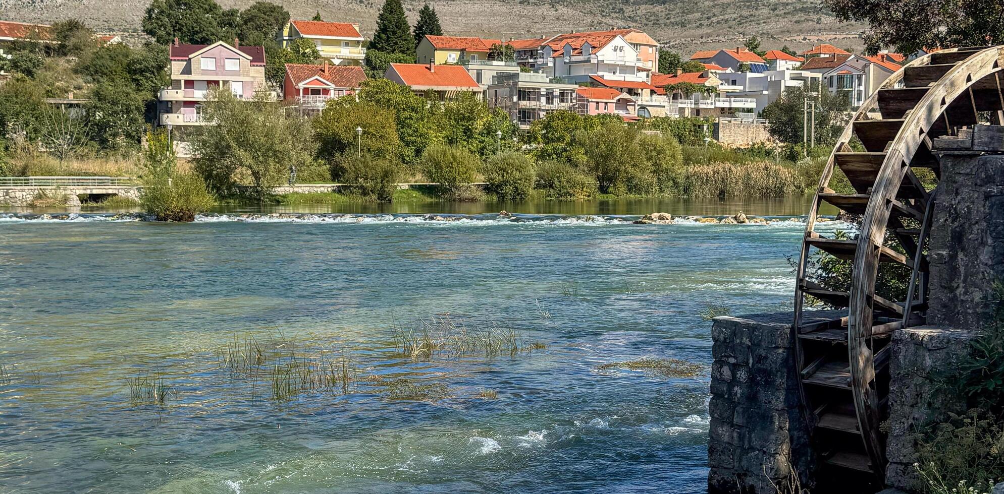 Cityscape from the Trebisnica River from an old water wheel. Trebinje, Bosnia and Herzegovina, 2 October 2024 photo