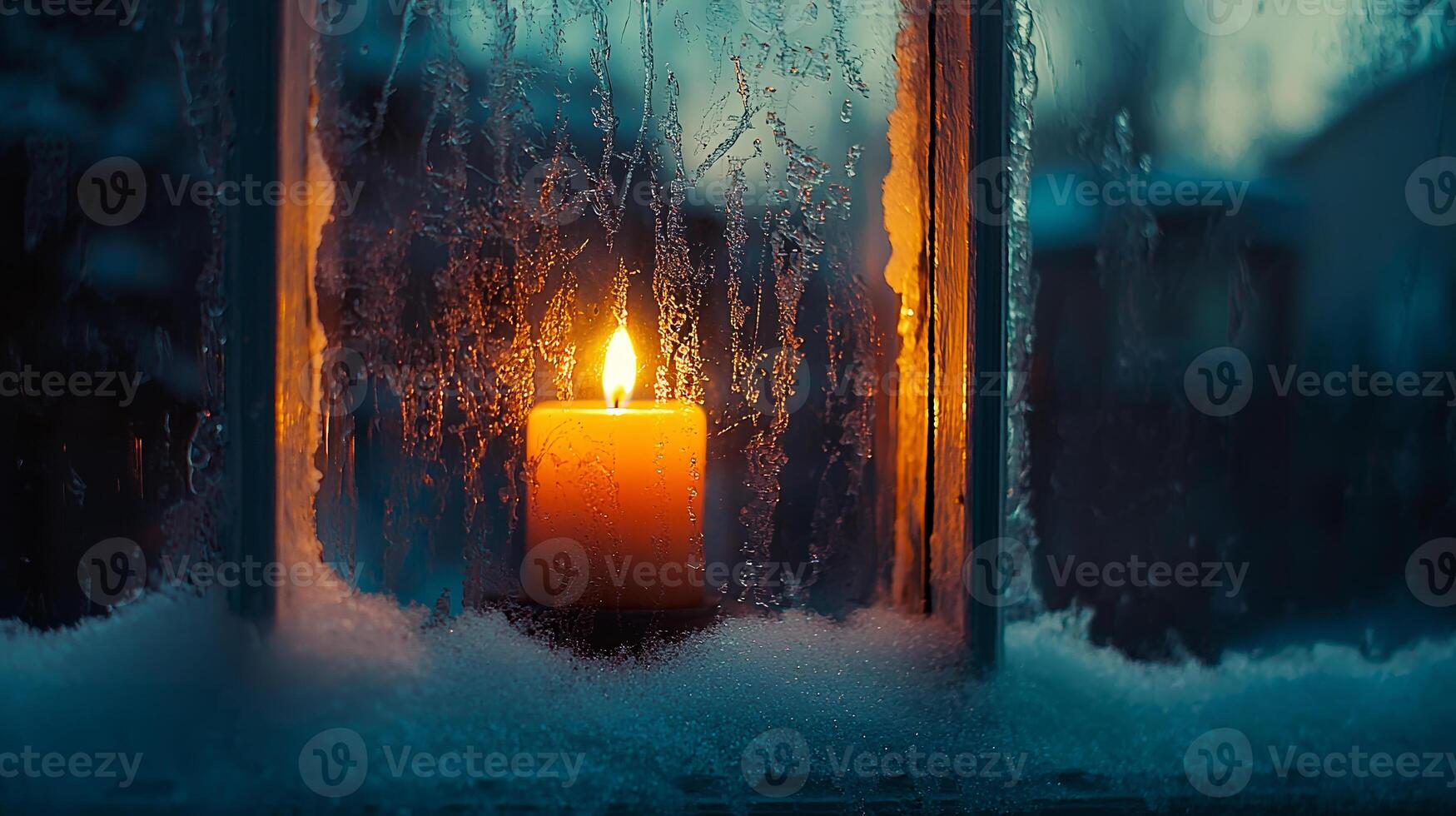 Candle glowing warmly through frost covered window, creating cozy atmosphere photo