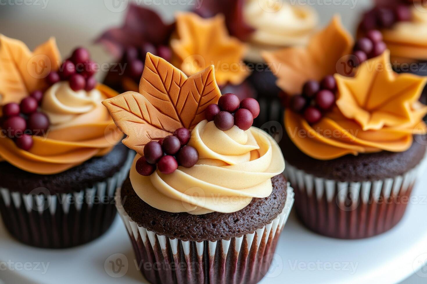 Autumn-inspired cupcakes are adorned with creamy frosting and festive decorations, featuring charming pumpkins, leaves, and acorns, making them perfect treats for fall gatherings. photo