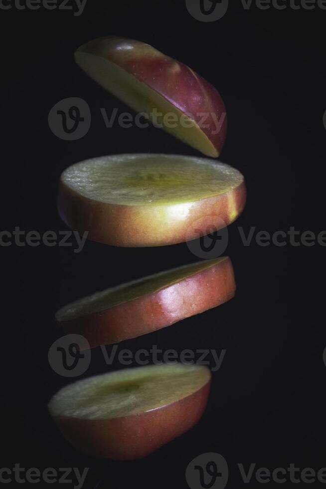 Sliced apple floating in th air,black background, photo