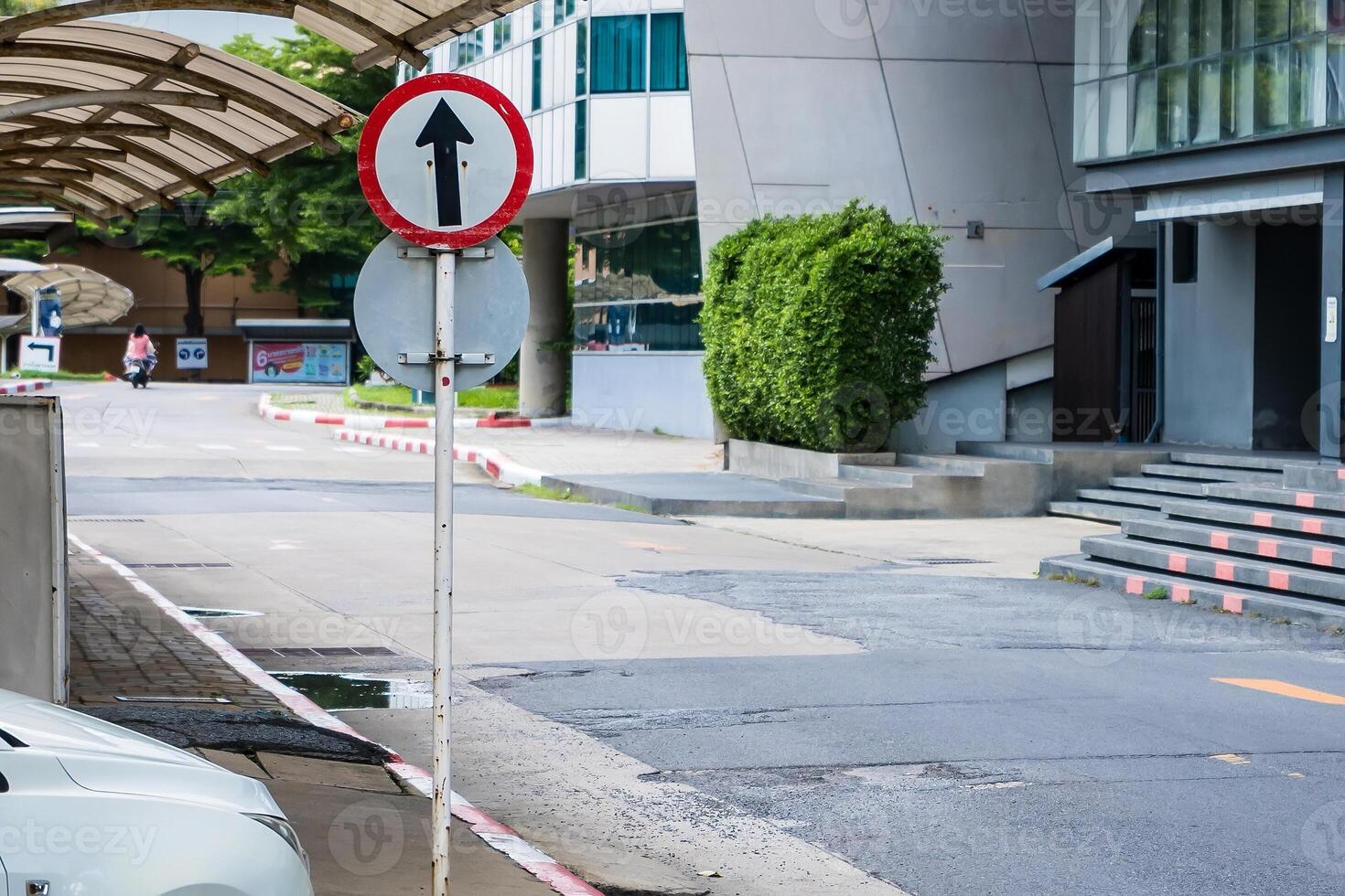 Directional Clarity in Urban Spaces.A Vivid Image of Go Straight Signage Amidst Cityscape at Nonthaburi, Thailand photo