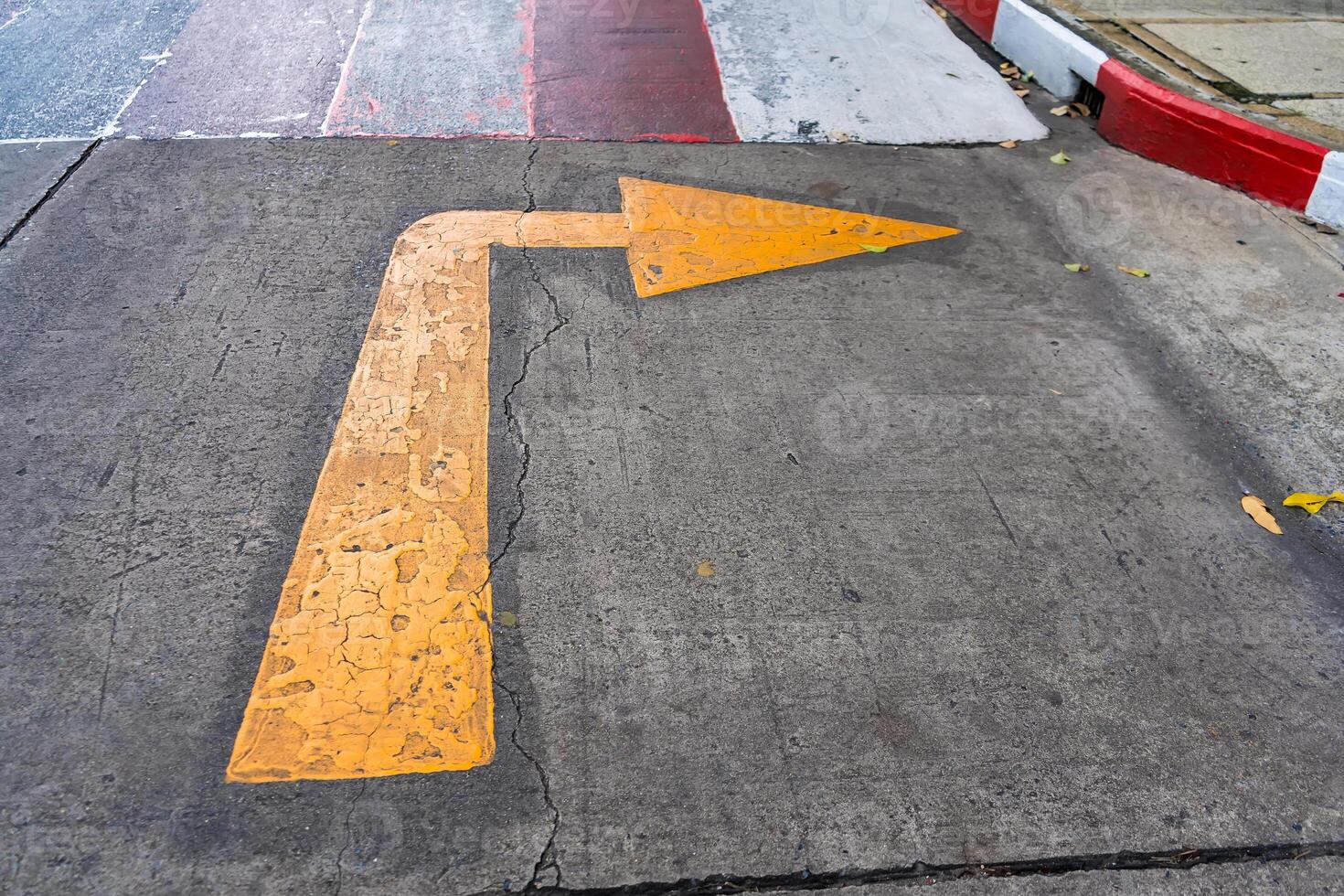 Yellow Arrow on Concrete Surface - Symbolizing Direction photo
