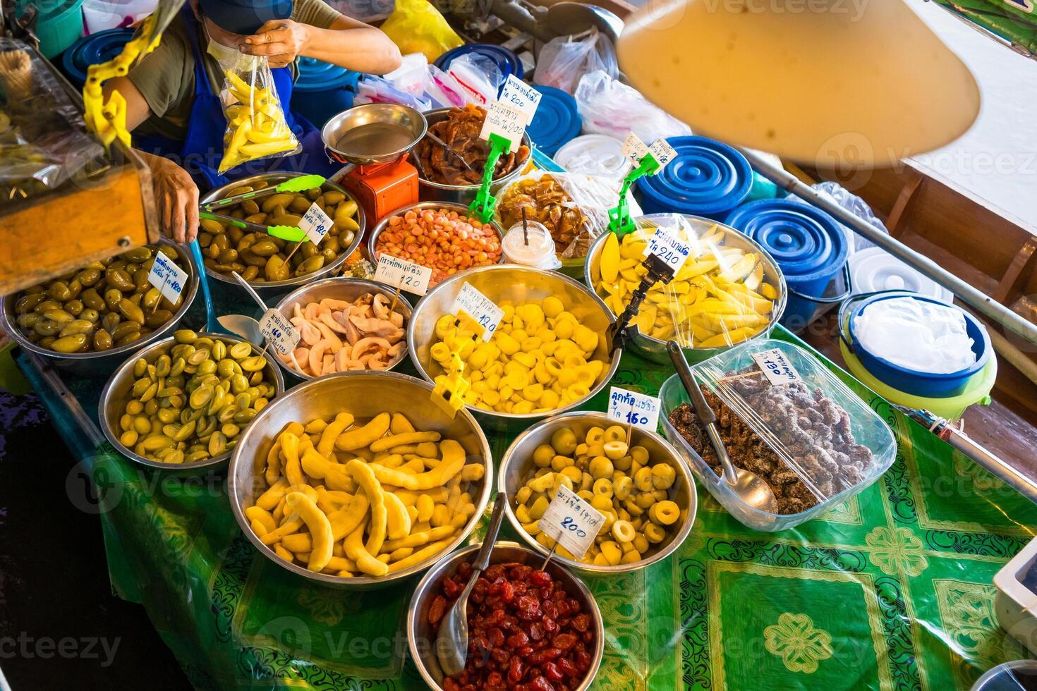 Nonthaburi, Thailand - July, 11, 2024 - Traditional Thai Boat Selling Assorted Pickled Fruits at the Floating Market at Nonthaburi, Thailand photo