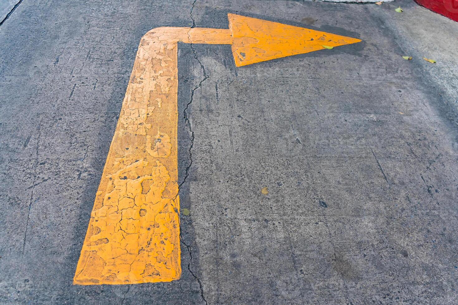 Yellow Arrow on Concrete Surface - Symbolizing Direction photo