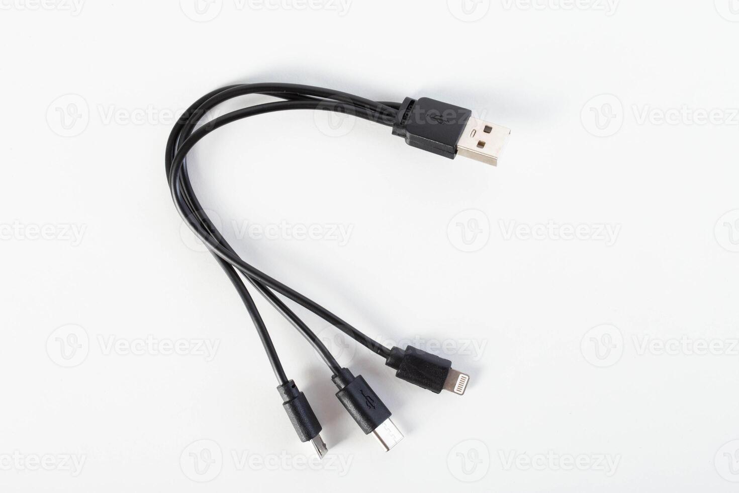 Universal black 3 in 1 charging cable with different charging connectors on a white background, close-up. Type-c, usb-c, micro-usb photo