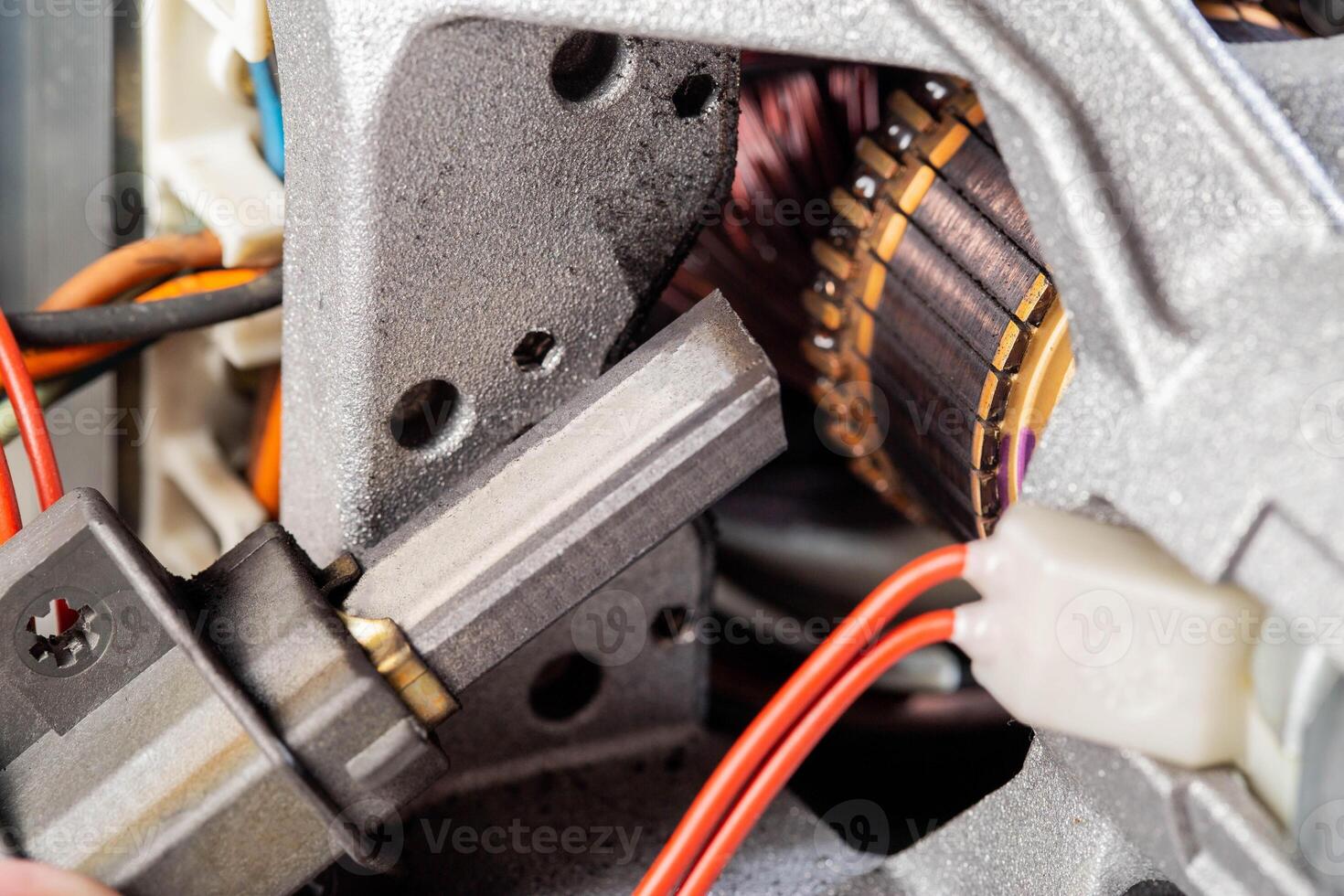 Replacing graphite electric motor brushes, close-up, industry. Copy space for text photo