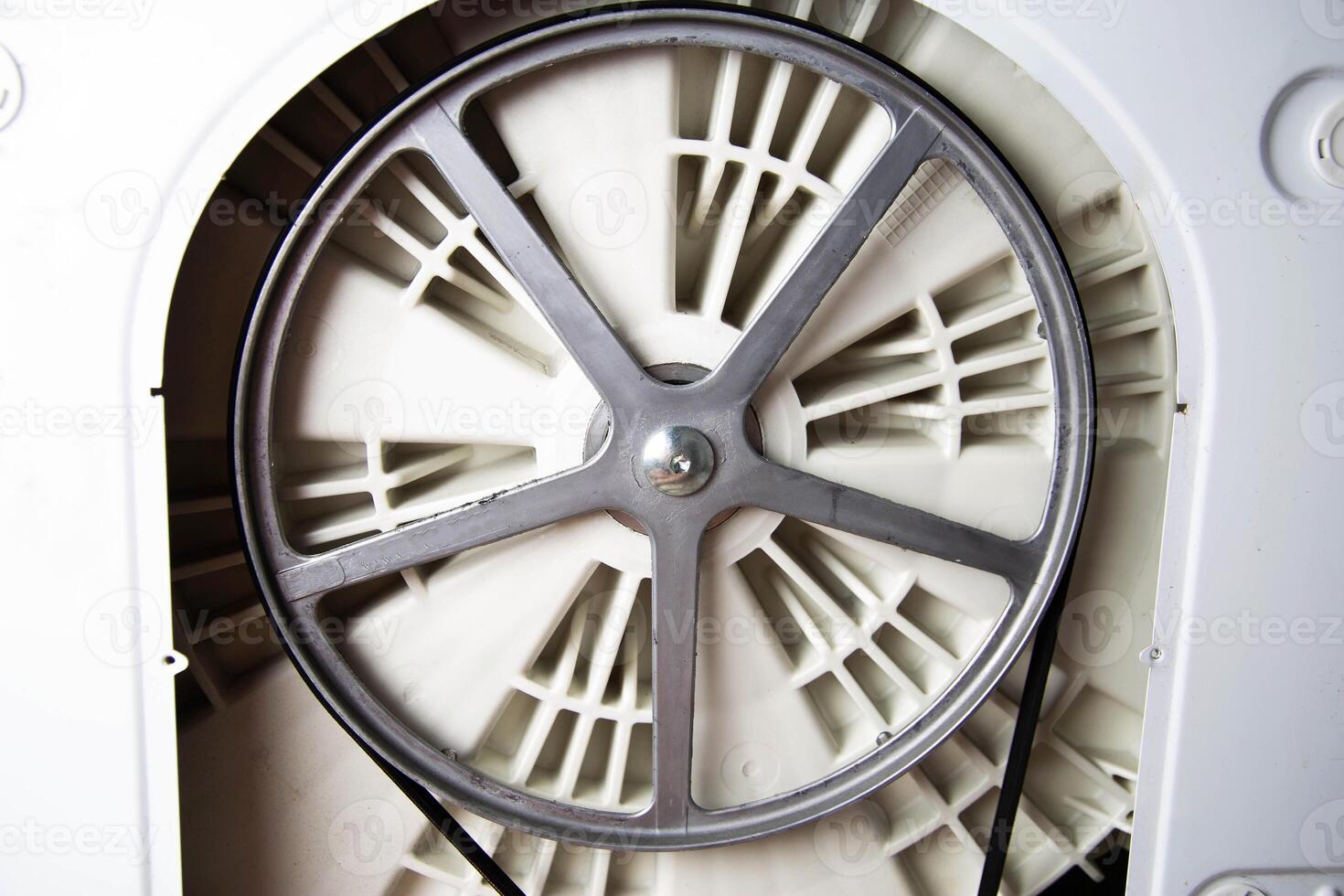 Washing machine pulley with belt. Breakage and replacement of belt with pulleys, close-up photo