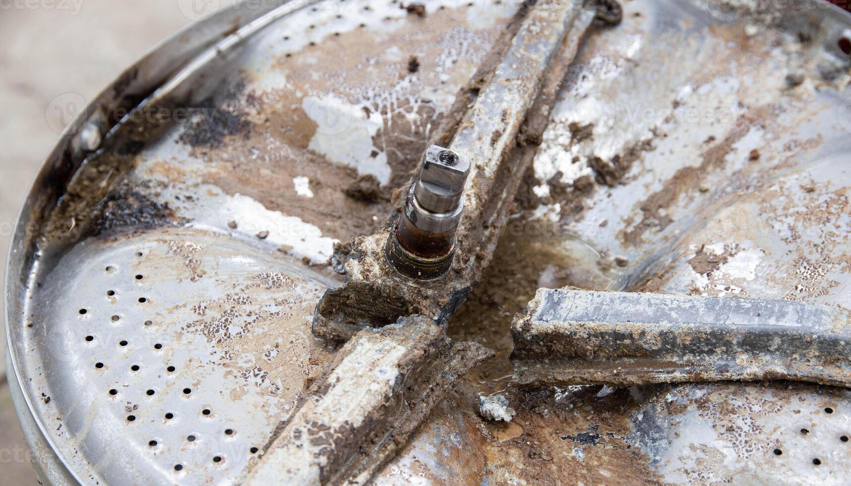 Breakage of the metal cross in the washing machine and non-separable drum. Fault in washing machines, close-up photo
