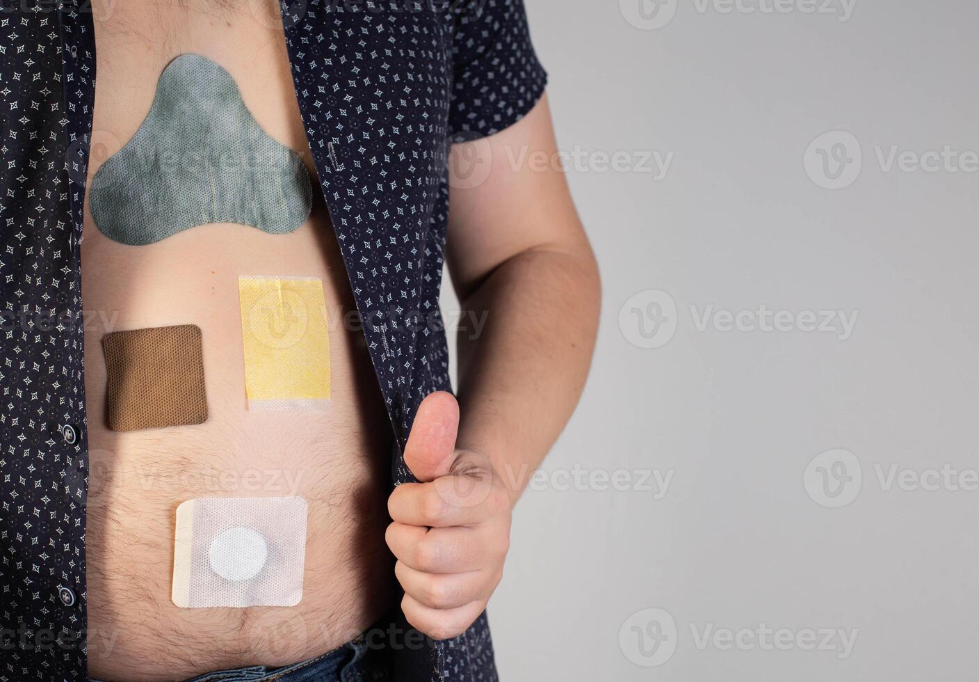 Various medical plasters are glued on the human body. Plaster from chronic prostatitis and painkiller. Anti-tobacco and anti-inflammatory. The concept of self-healing. Copy space for text photo