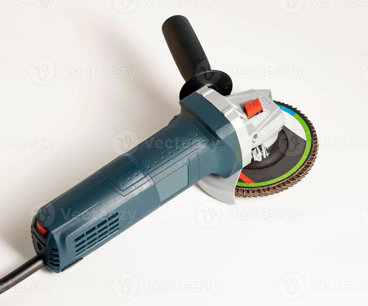 Professional angle grinder with flap wheel for processing wooden surfaces. Construction power tool. Industry, close-up photo