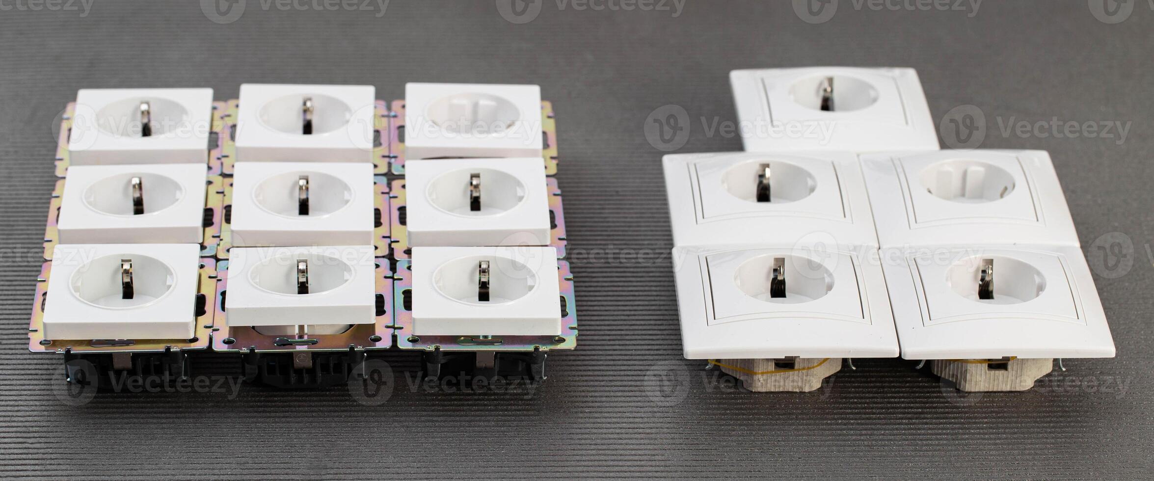 Many modern electrical sockets on a gray background, close-up. Rise in the price of electricity price per kilowatt, saving electricity, close-up photo