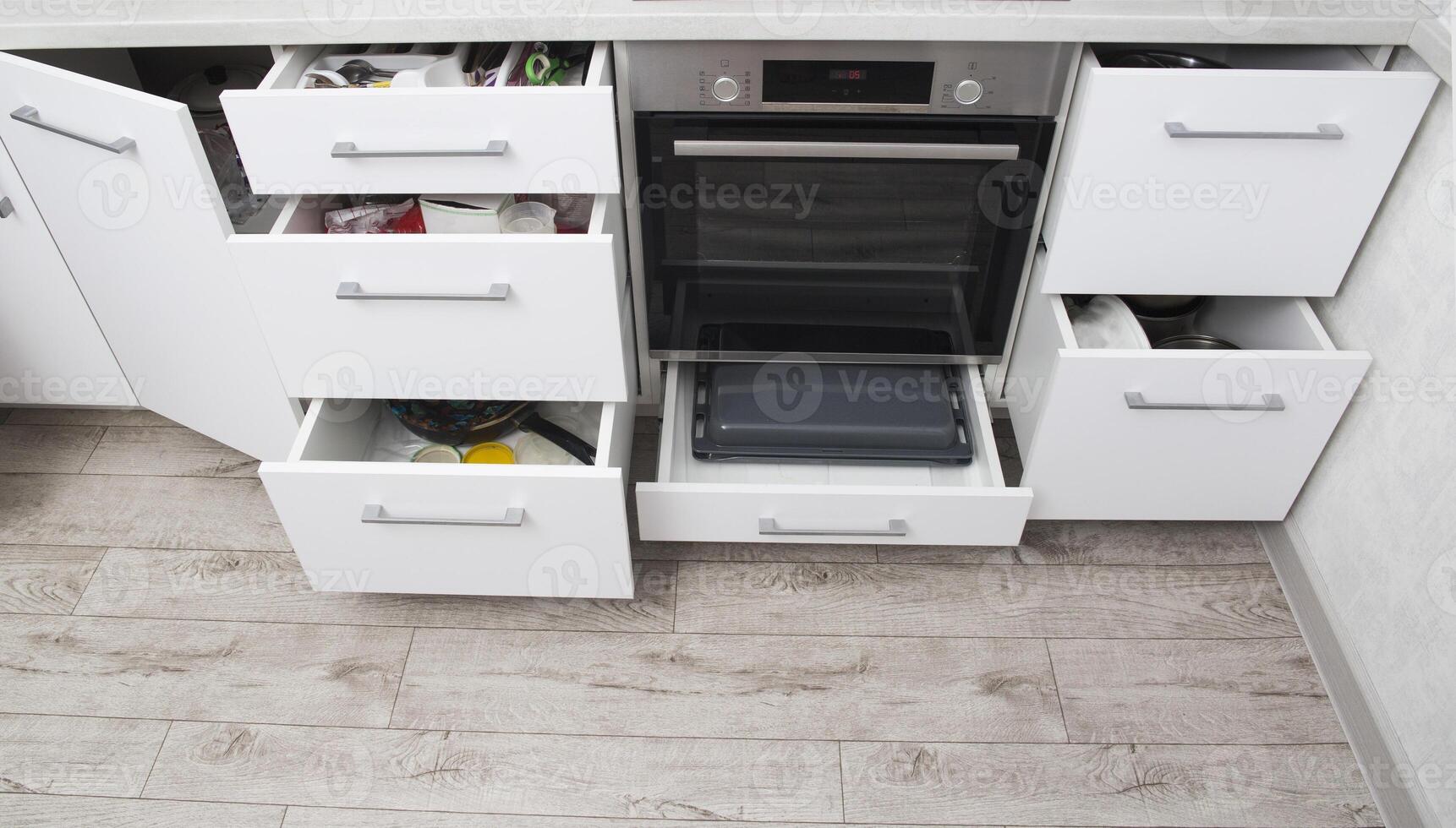 Organization of storage of utensils in the kitchen. Modern headset and planning for the manufacture of a section and drawers in the kitchen. Convenience of the location of dishes. photo