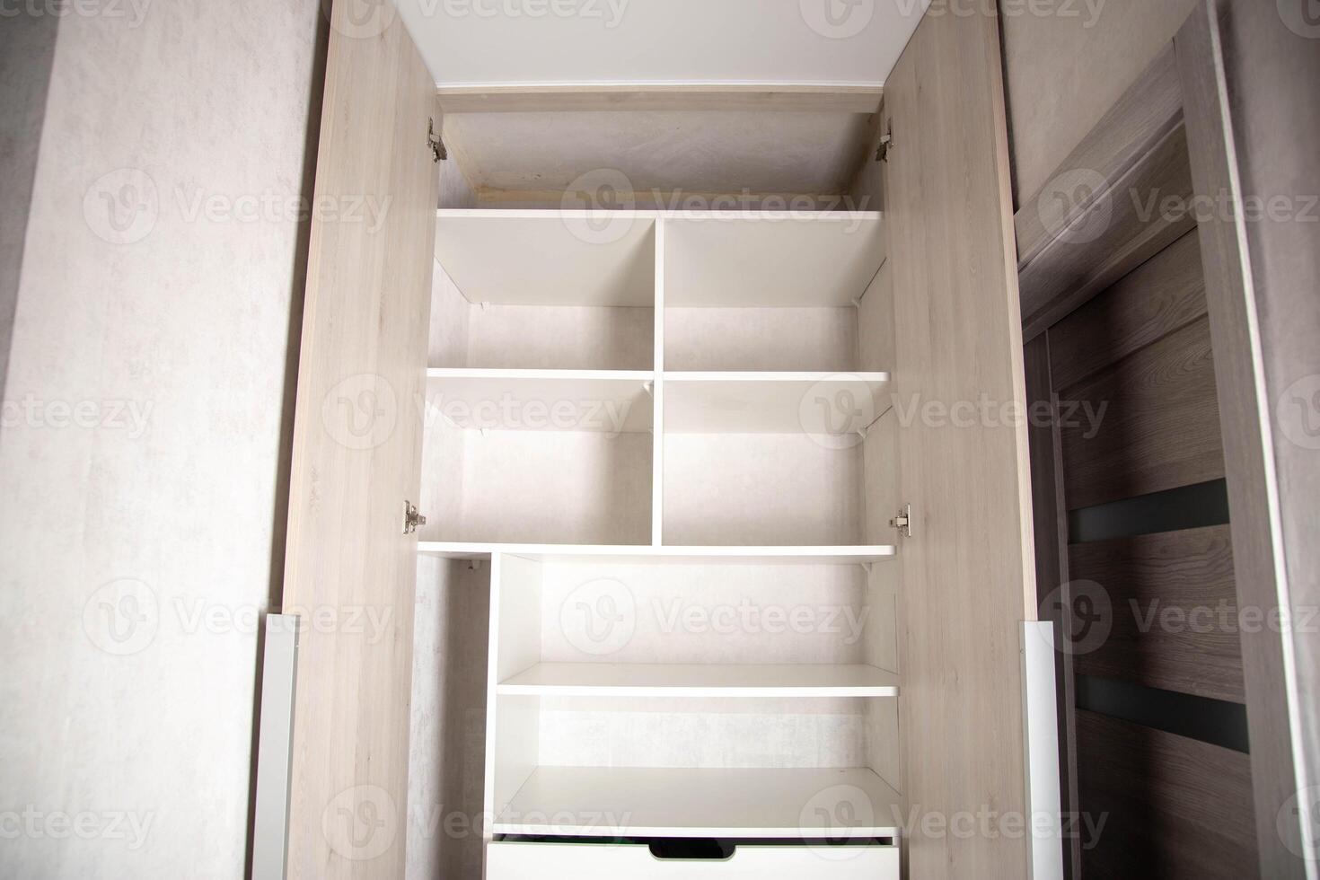 Modern closet in the hallway with hinged doors and pull-out shelves. Production of furniture under the order. photo