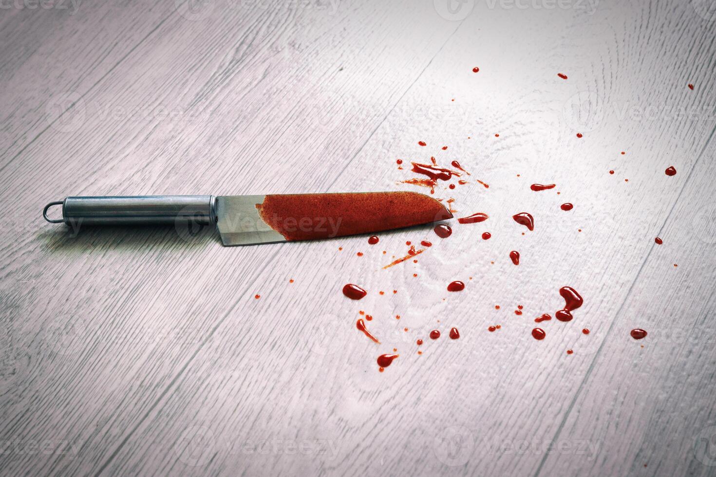 The blade of the knife in the blood lies on the floor. Stabbing and injury, crime. Aggression photo