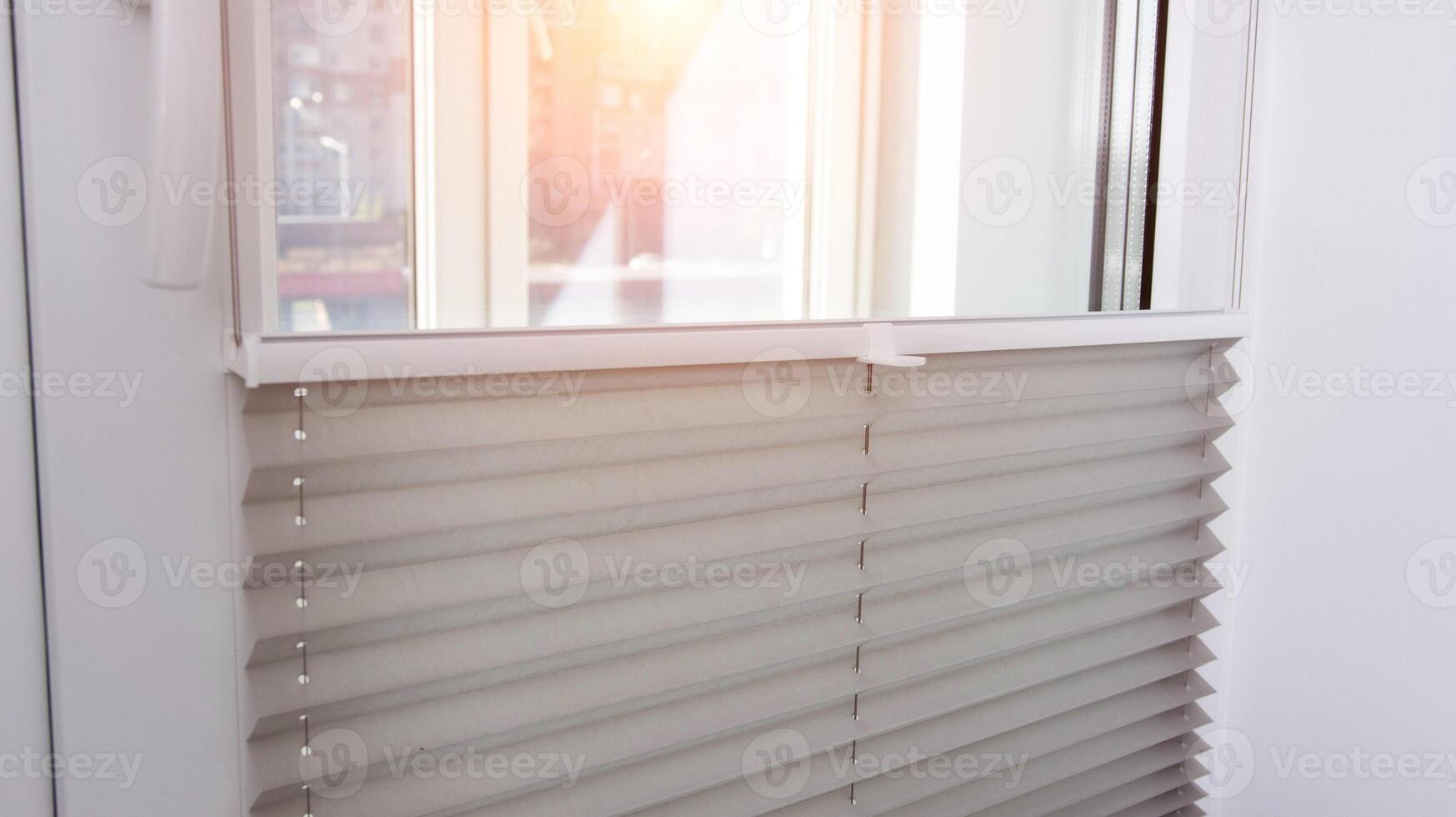 Modern classic aluminum blinds on the window sash with a scaffold fixing system. Protection from prying eyes and the sun. photo
