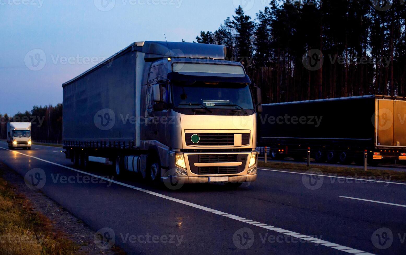 A beautiful truck with a trailer against the backdrop of an evening sunset before night. The concept of work and rest regime for truck drivers. Fine for breaching rules photo