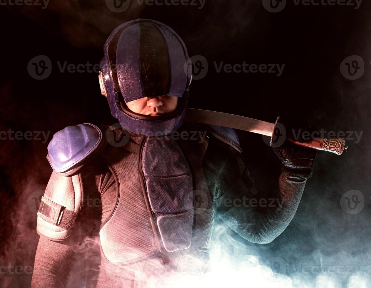 Cyberpunk future concept. Bionic cyborg police officer with short samurai sword stands in dark with smoke, fume. Halfman robot looks at camera. Futuristic science fiction scene. photo