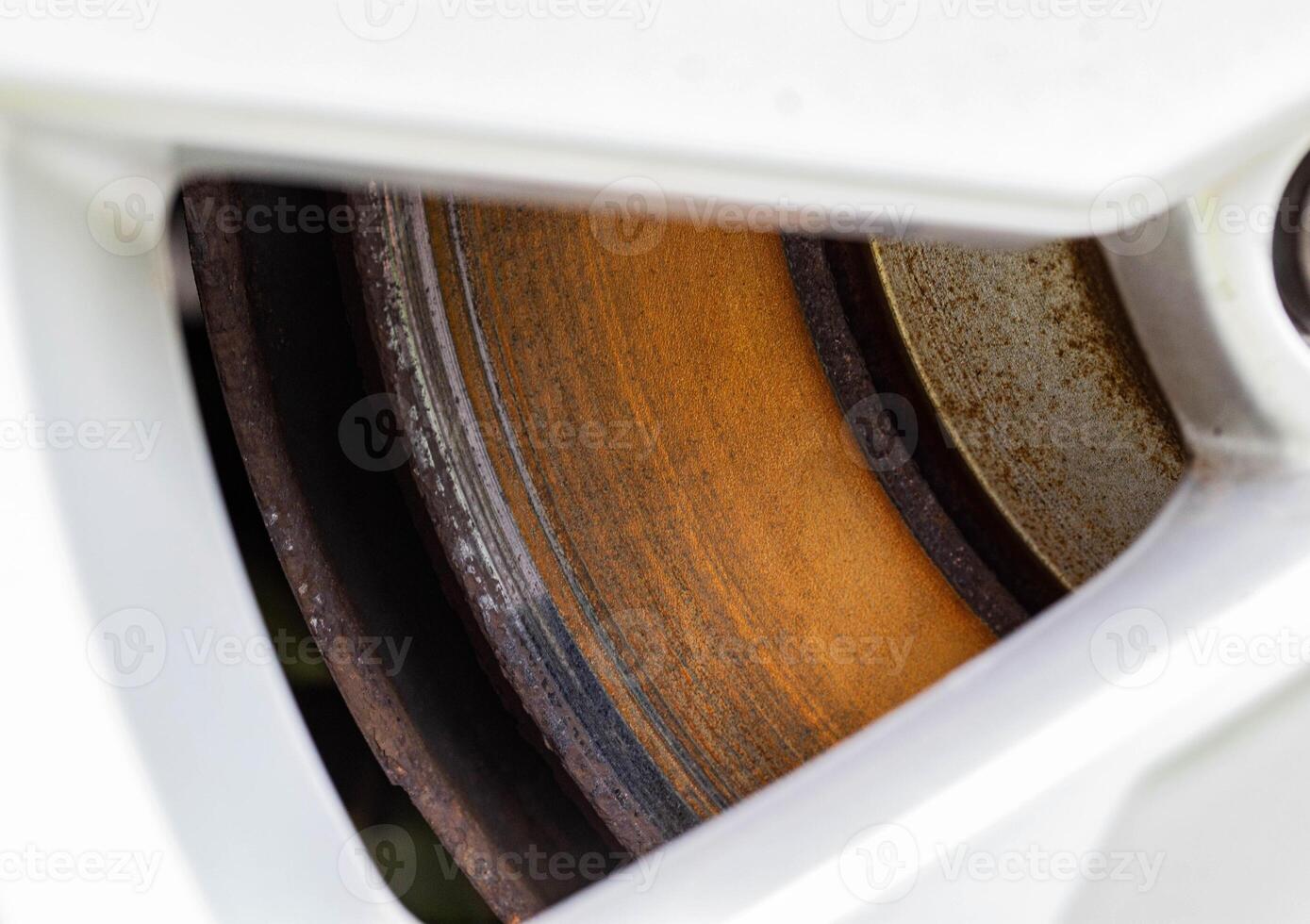 Rusty, defective brake disc with a shoulder on the edge. Worn brake disc concept, brake failure, macro photo