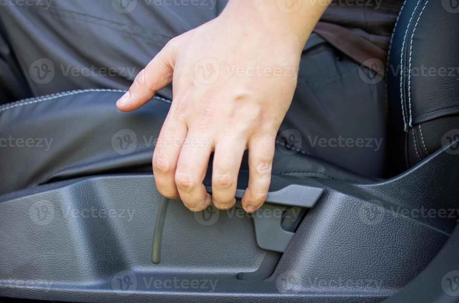 Mechanical adjustment of the height of the driver's seat in the car, close-up photo