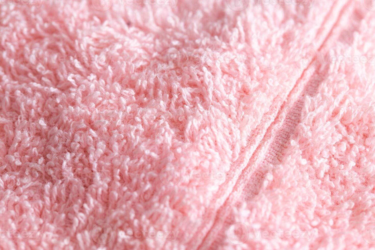 Texture background fabric with pile. Pink soft cloth, macro photo