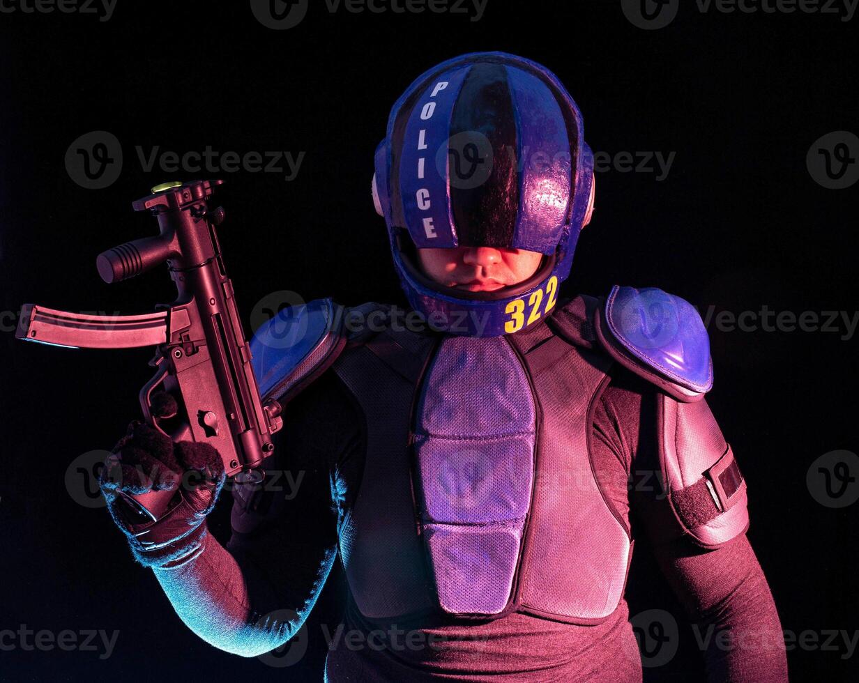 Cyberpunk concept, future world. Police officer cop in dark, halfman bionic cyborg or reloads gun, twitches cocking lever, Stands looks at camera in dark. Science fiction scene, fantasy, sci. photo