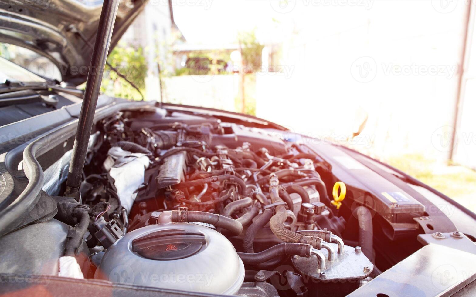 Modern diesel engine on a car with an open hood. Copy space for text, sun photo