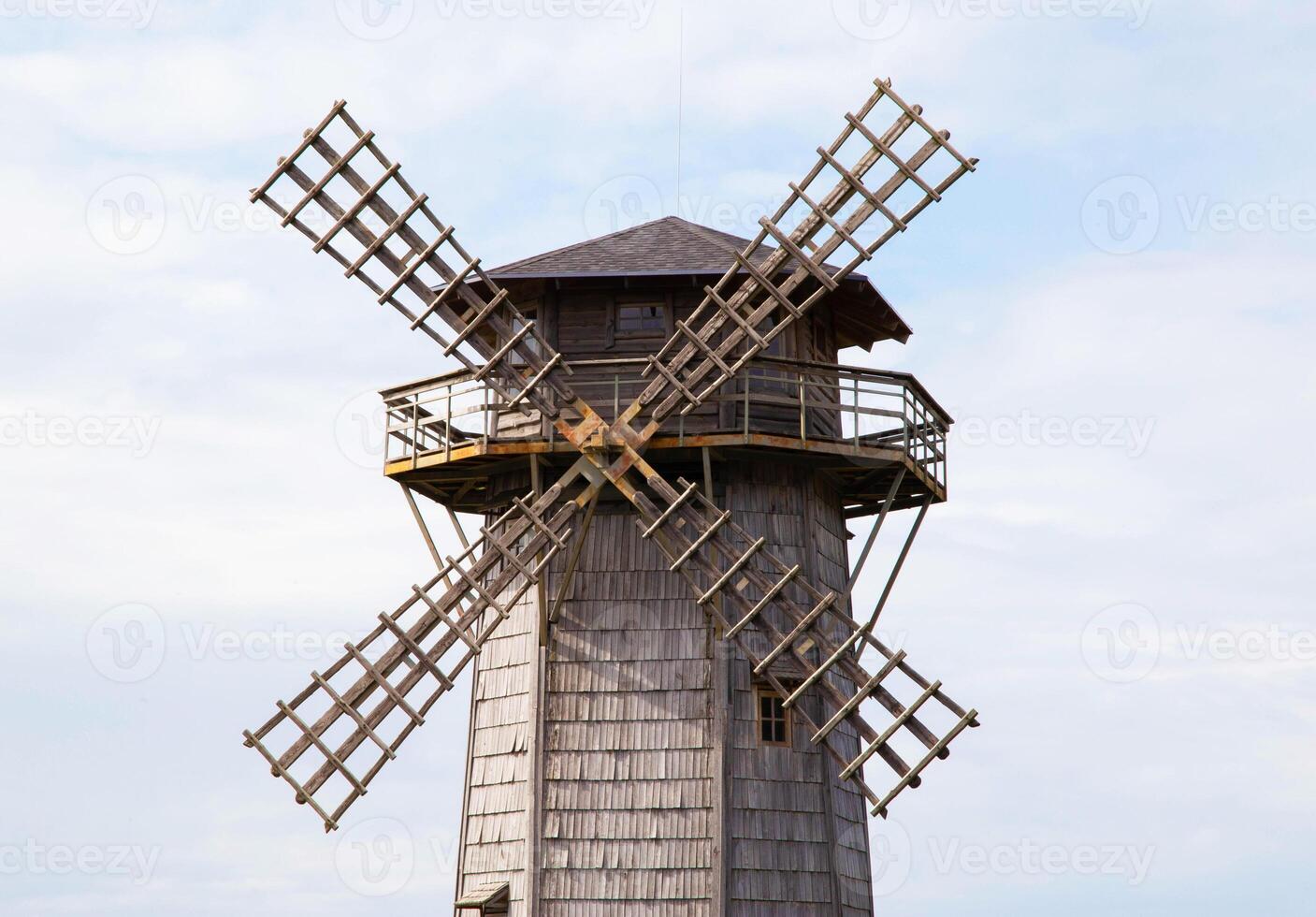 Blades of an old wooden mill against the background of the sky. Old traditions, close-up photo