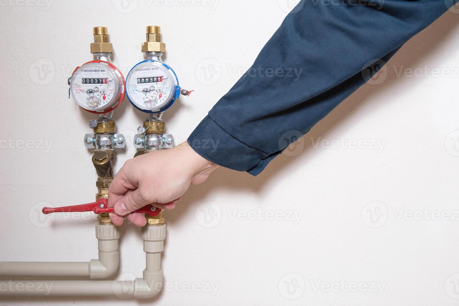 A man turns off a hot water faucet. Planned shutdown of hot water and repair of the heating main. Copy space for text photo