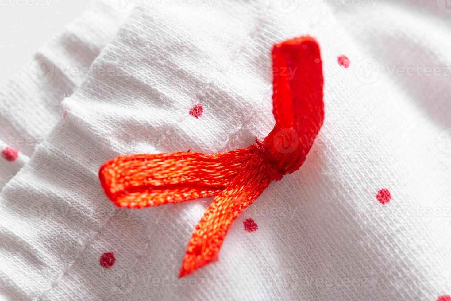 white clothes with red patterns and elastic band, macro photo