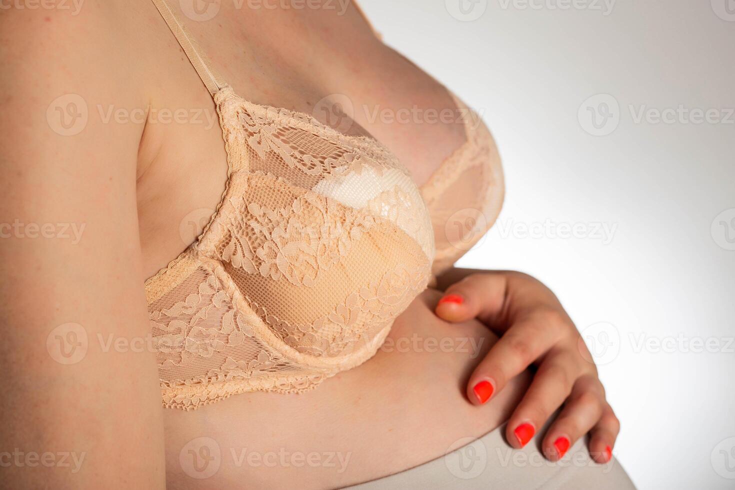 Bra on the female breast with special inserts to protect the female breast from getting wet with milk, close-up photo