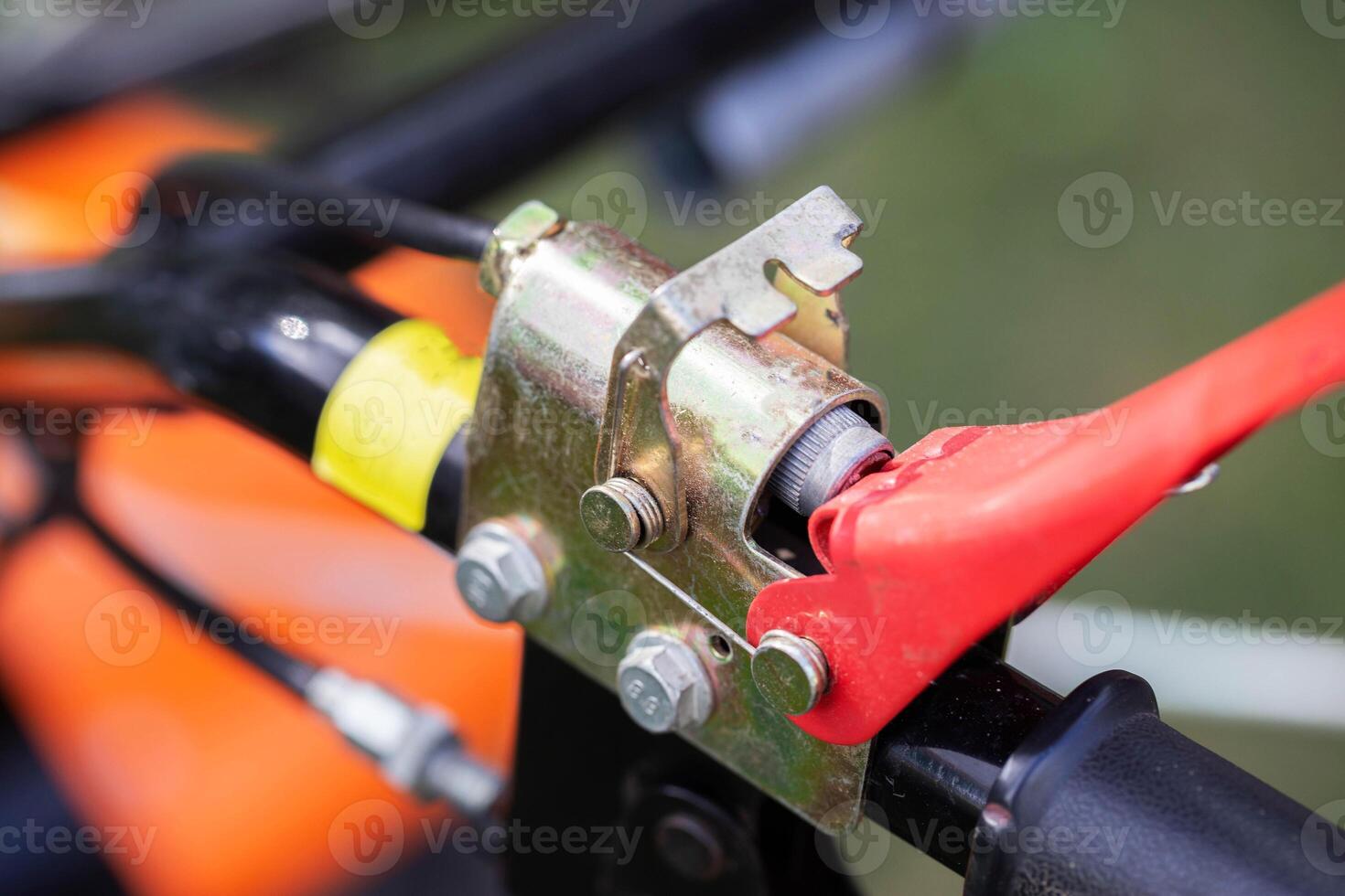 button for safely turning off the engine of the walk-behind tractor, close-up photo
